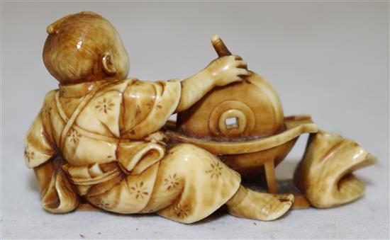 A Japanese ivory netsuke of a boy grinding seed?, Meiji period, 5.1cm